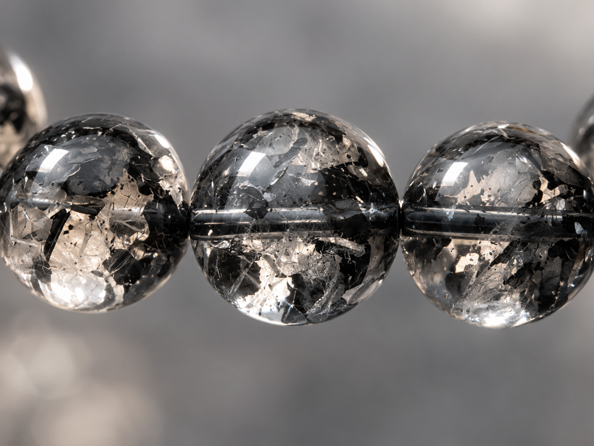 Close-up of black foil-like patterns in treated crystal beads
